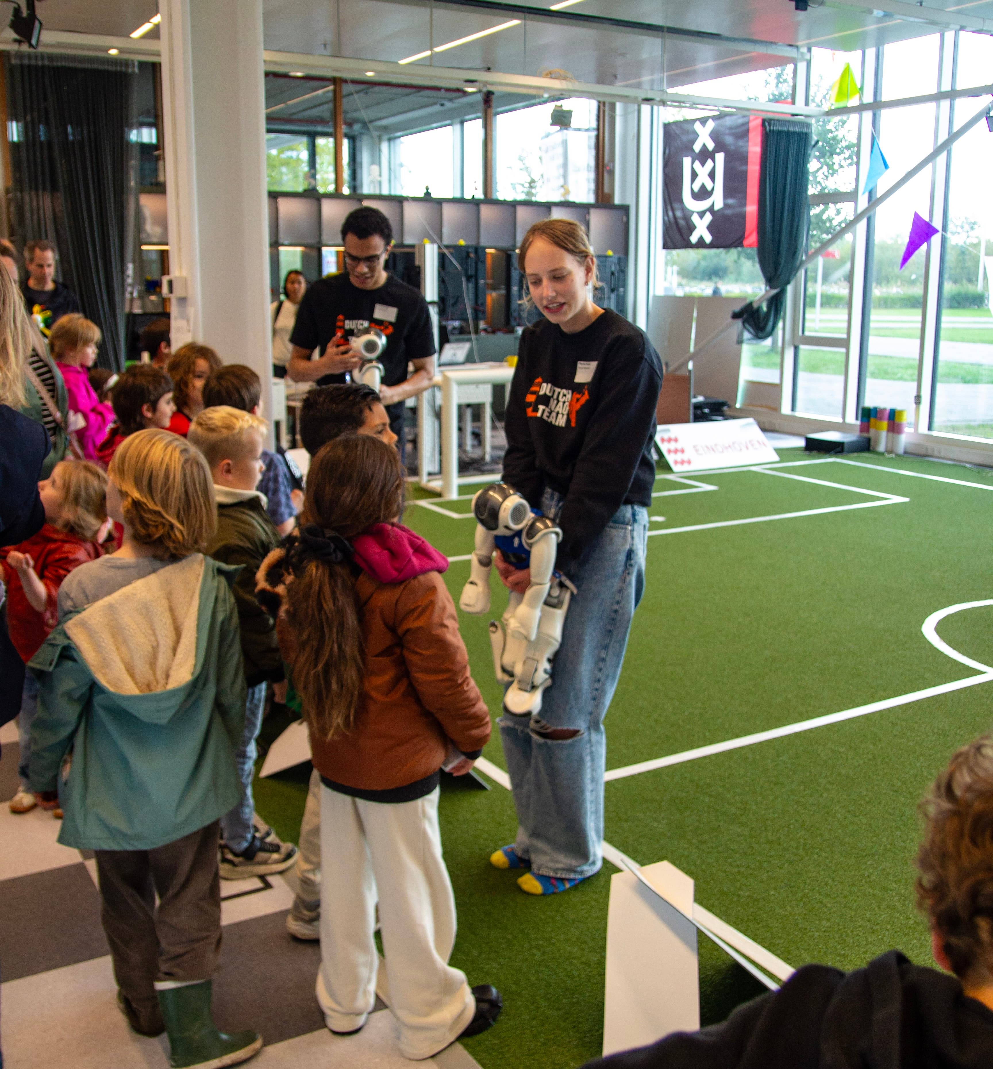 The team showing a NAO robot to visitors in the Lab